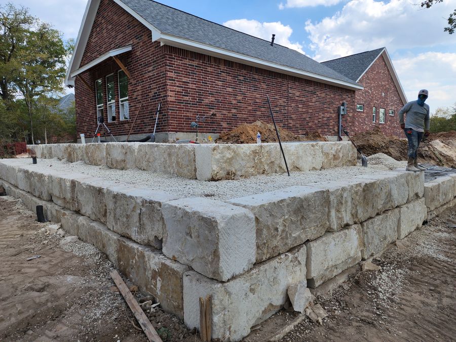 Limestone perimeter wall around new construction