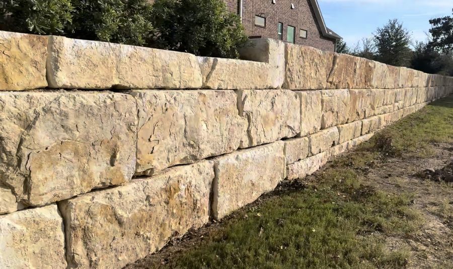 Long dry-stacked limestone retaining wall